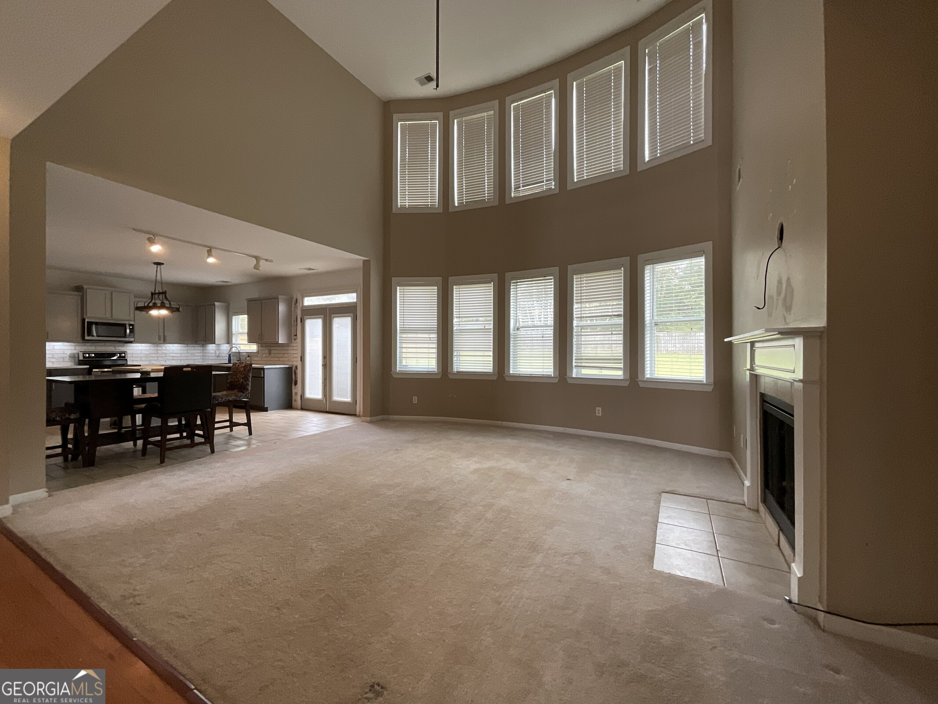 302 Brampton Way Perry, GA 31069 - Photo 11 of 39 a view of an empty room and kitchen with furniture