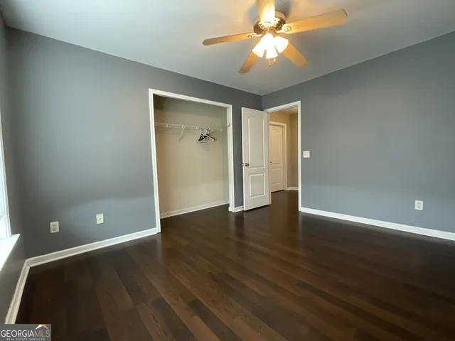 an empty room with wooden floor and door