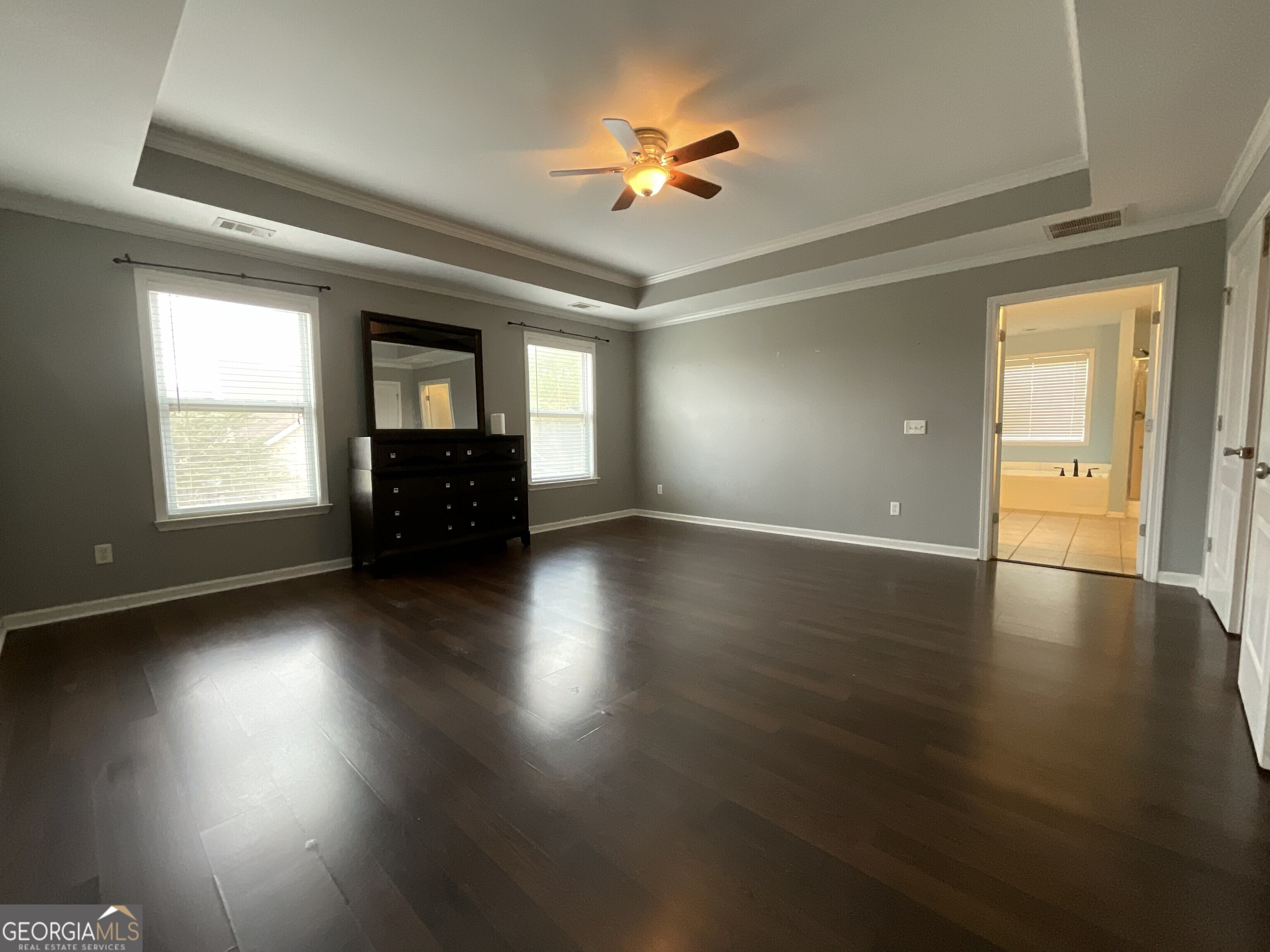 302 Brampton Way Perry, GA 31069 - Photo 24 of 39 an empty room with wooden floor chandelier fan and windows