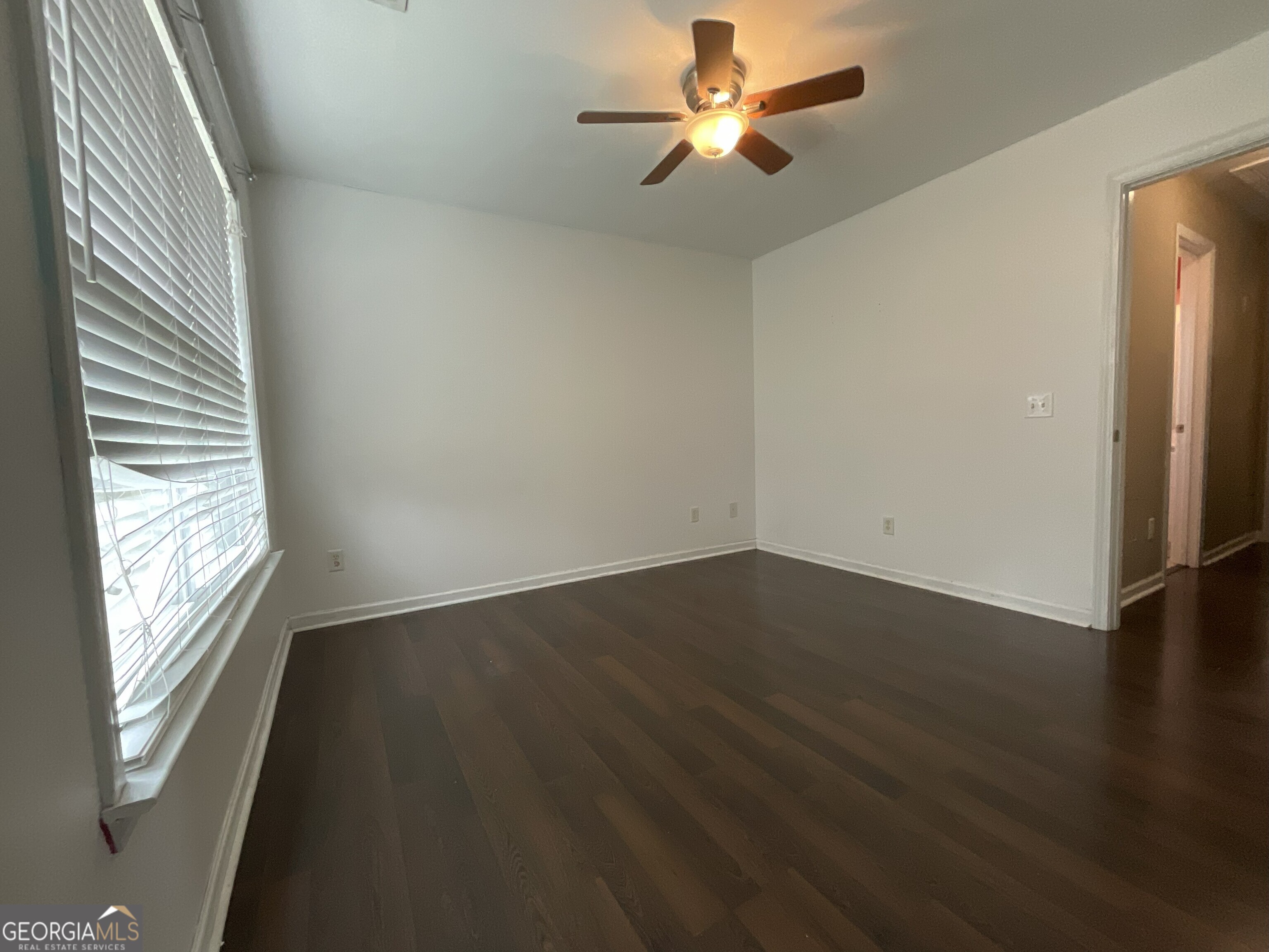 302 Brampton Way Perry, GA 31069 - Photo 30 of 39 an empty room with wooden floor fan and windows