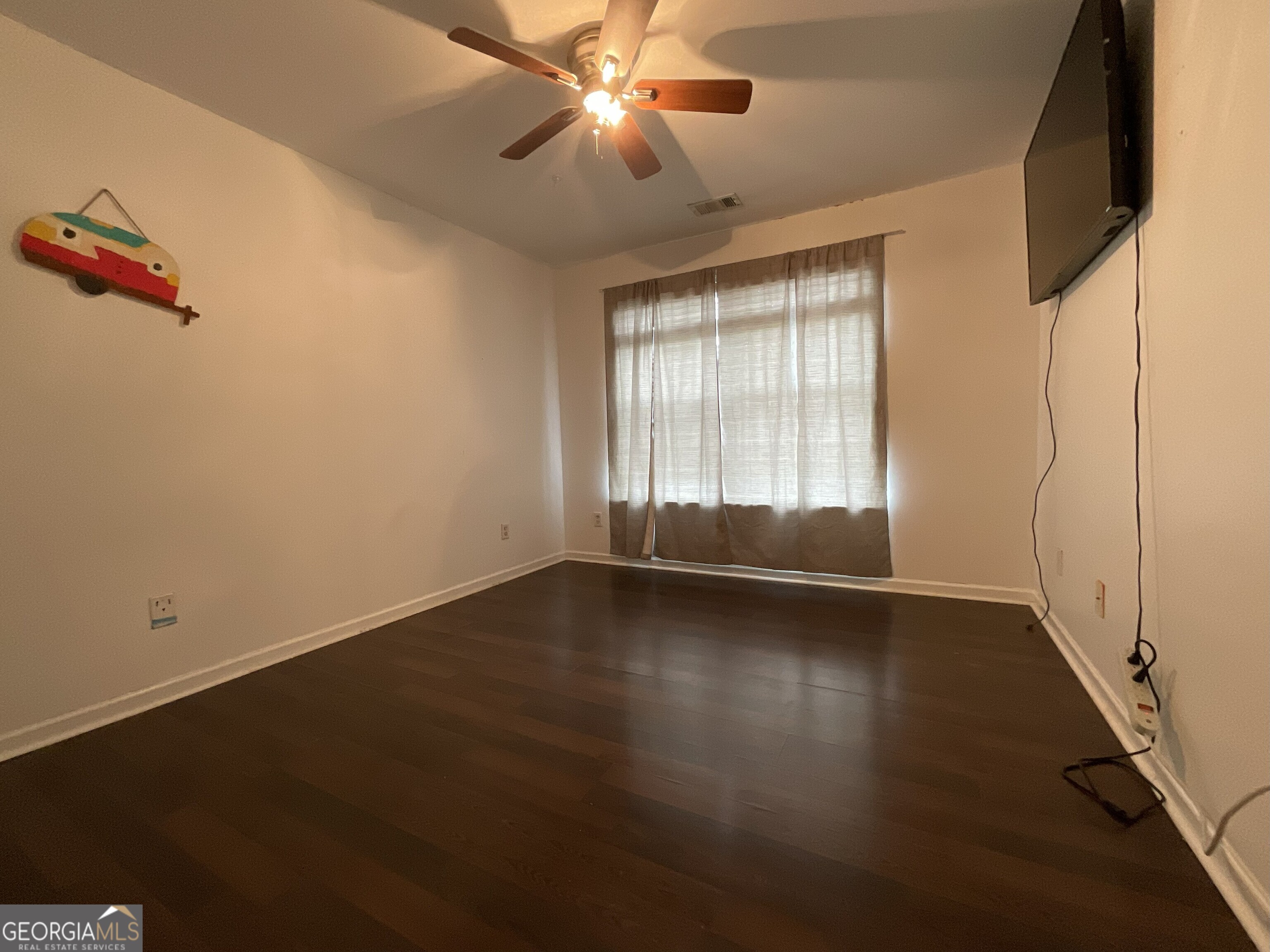 302 Brampton Way Perry, GA 31069 - Photo 31 of 39 an empty room with wooden floor and windows