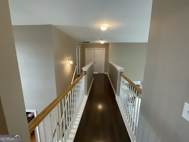 a view of a hallway with stairs