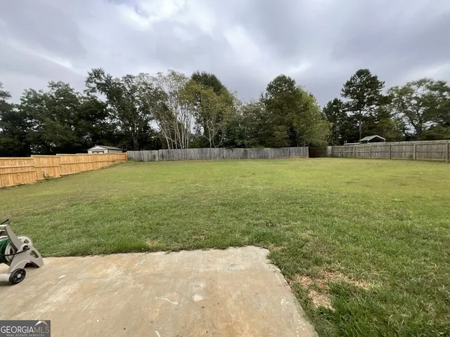 a view of outdoor space with green field and trees around