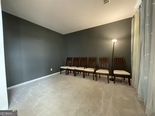 a view of a room with furniture and a rug