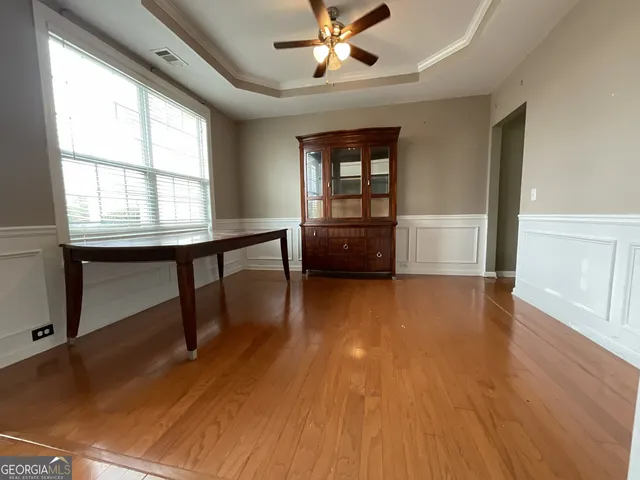 a view of a livingroom with furniture wooden floor and window