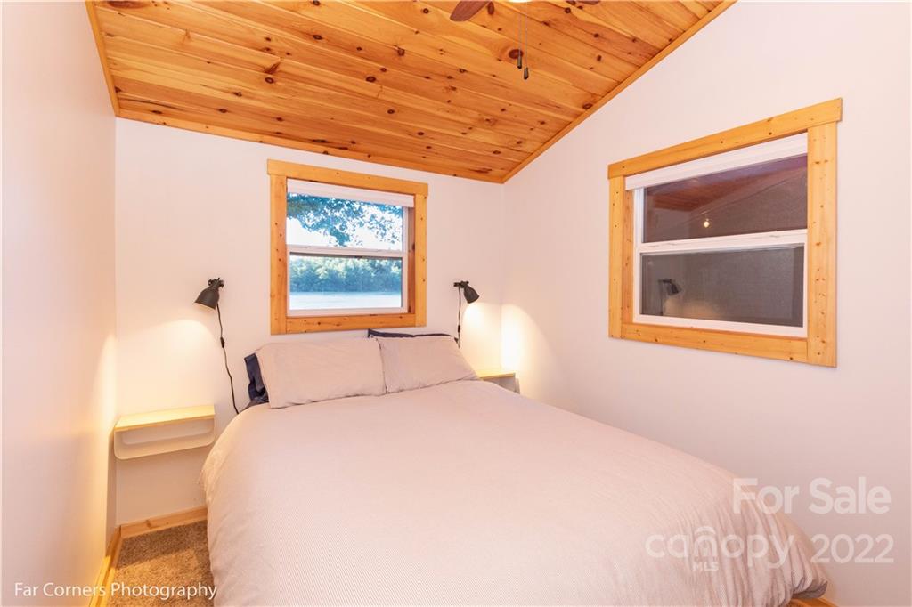 588 Thunderbird Trail Robbinsville, NC 28771 - Photo 11 of 20 a bedroom with a bed and a painting on the wall