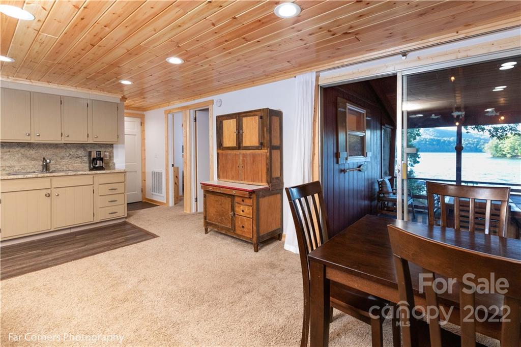 588 Thunderbird Trail Robbinsville, NC 28771 - Photo 15 of 20 a dining room with furniture and a floor to ceiling window