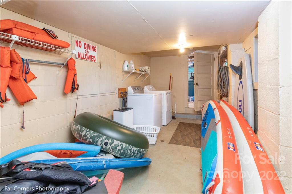 588 Thunderbird Trail Robbinsville, NC 28771 - Photo 17 of 20 a living room with furniture a rug and white walls
