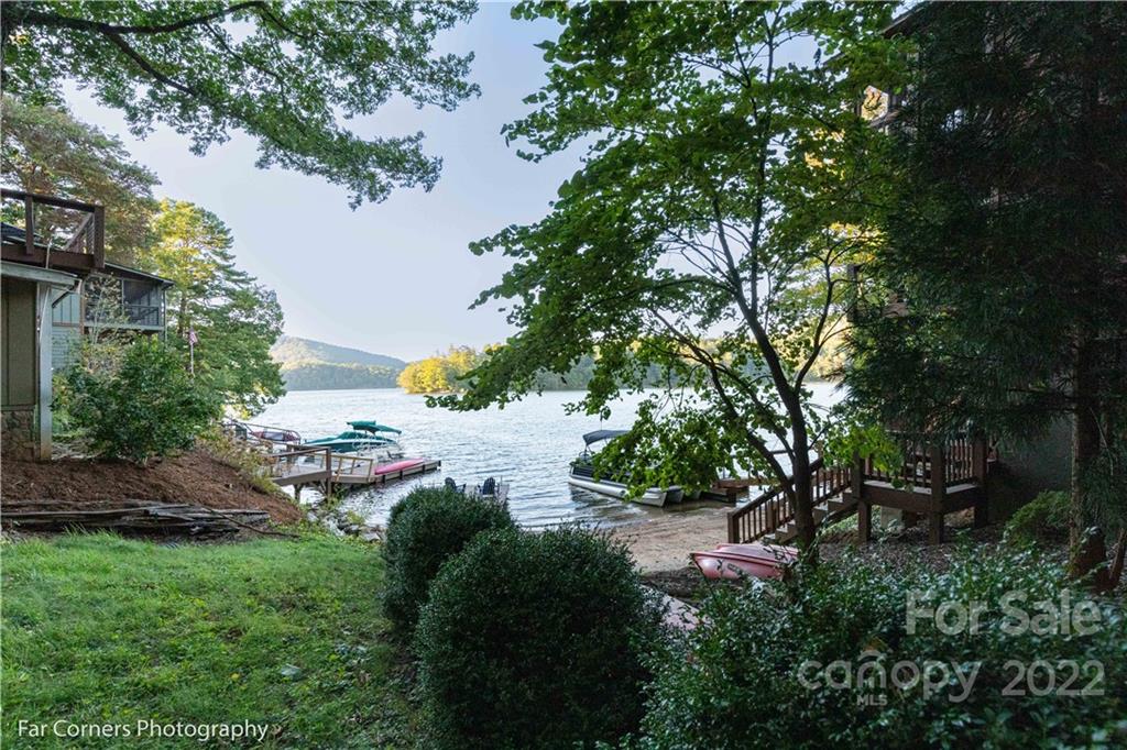 588 Thunderbird Trail Robbinsville, NC 28771 - Photo 19 of 20 a view of a garden with lawn chairs under an umbrella