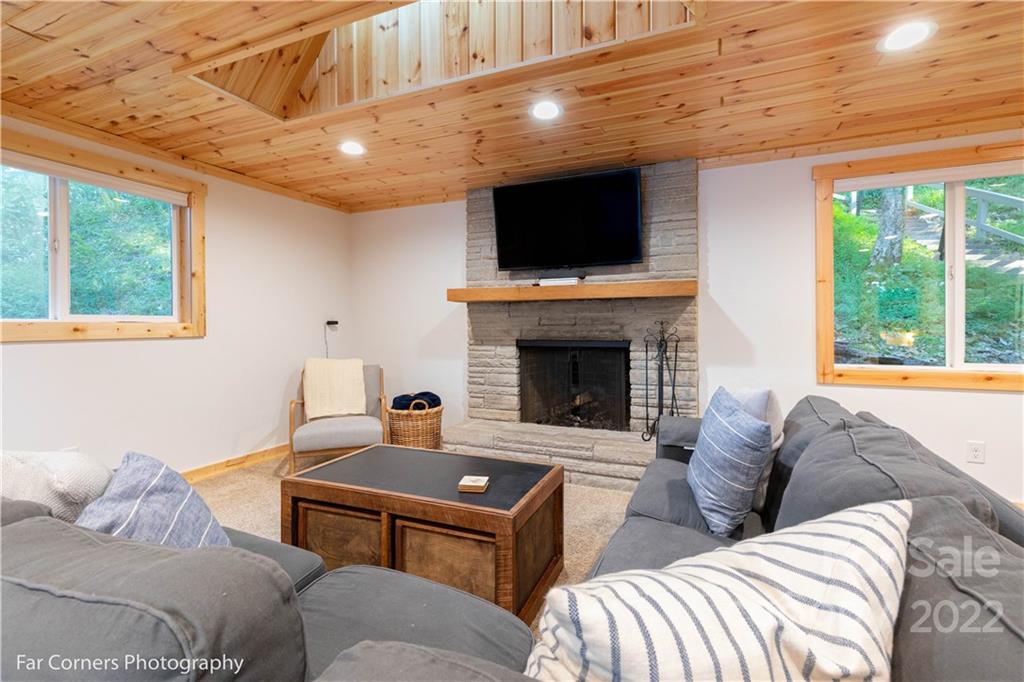 588 Thunderbird Trail Robbinsville, NC 28771 - Photo 4 of 20 a living room with furniture a flat screen tv and a fireplace