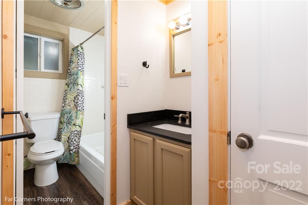 588 Thunderbird Trail Robbinsville, NC 28771 - Photo 10 of 20 a bathroom with a sink a toilet and shower