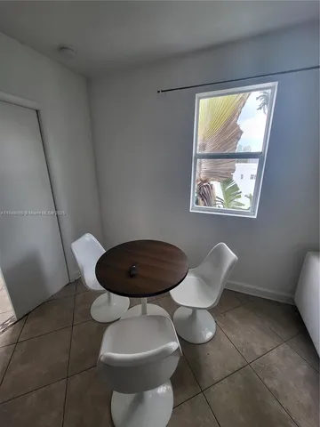 a bathroom with a toilet and a window