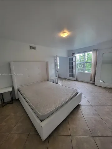 a bedroom with a bed and window