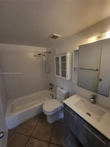 a bathroom with a sink toilet a mirror and shower