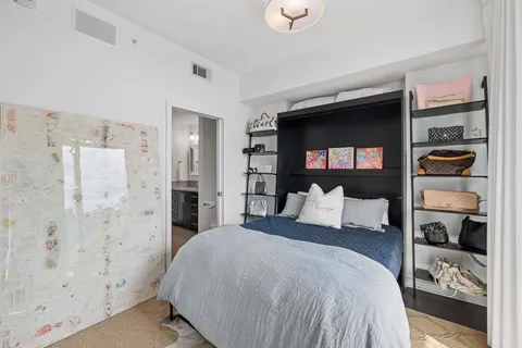 a bedroom with a bed and a walk in closet