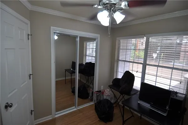 a view of a workspace with furniture and a window