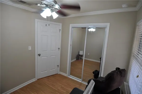 a view of a room with wooden floor and bathroom