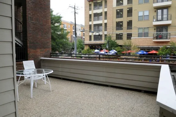 a view of a patio with a table and chairs and potted plants