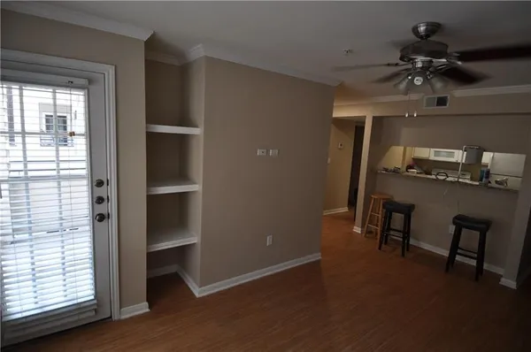 a view of a livingroom with a furniture window and wooden floor