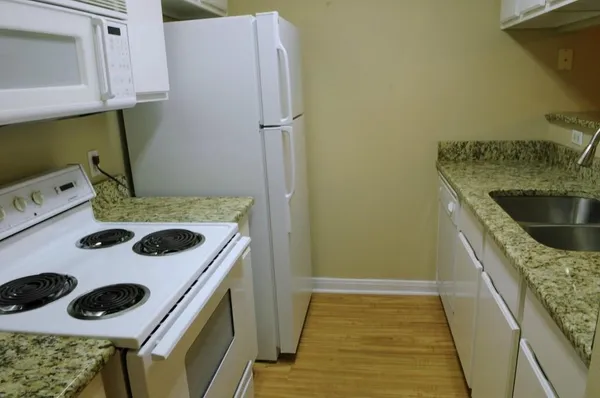 a kitchen with a stove and a refrigerator