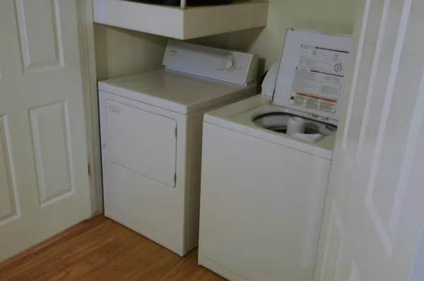 a view of storage and utility room with washer and dryer