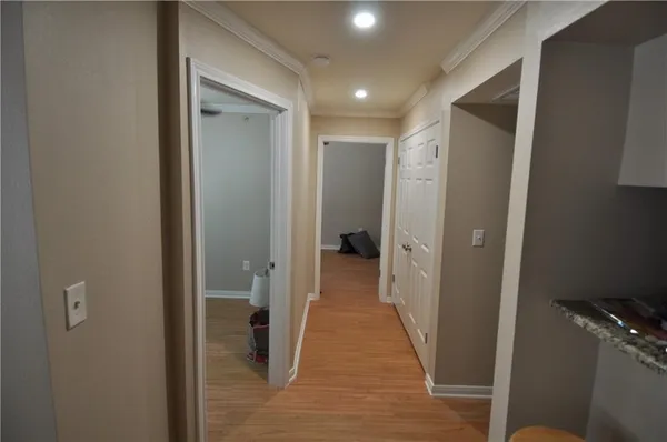 a view of a hallway with a door and stairs
