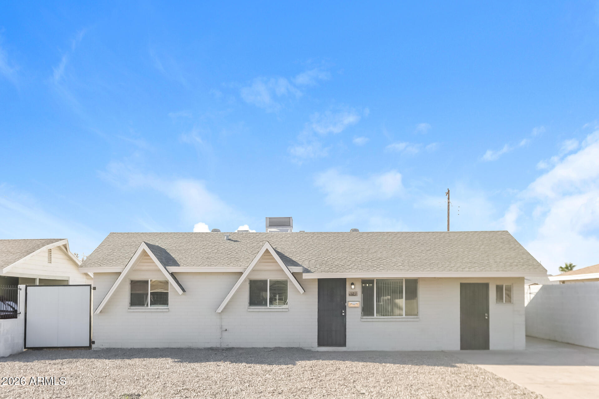 1323 West Romo Jones Street Tempe, AZ 85281 - Photo 1 of 16 a front view of a house with a yard