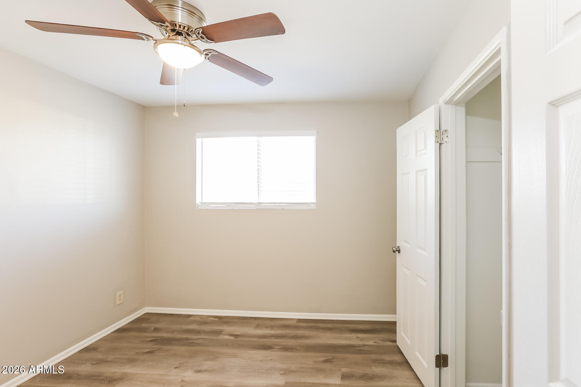1323 West Romo Jones Street Tempe, AZ 85281 - Photo 10 of 16 an empty room with wooden floor fan and windows