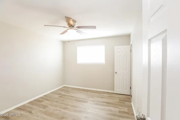 a kitchen with a sink a refrigerator and white cabinets