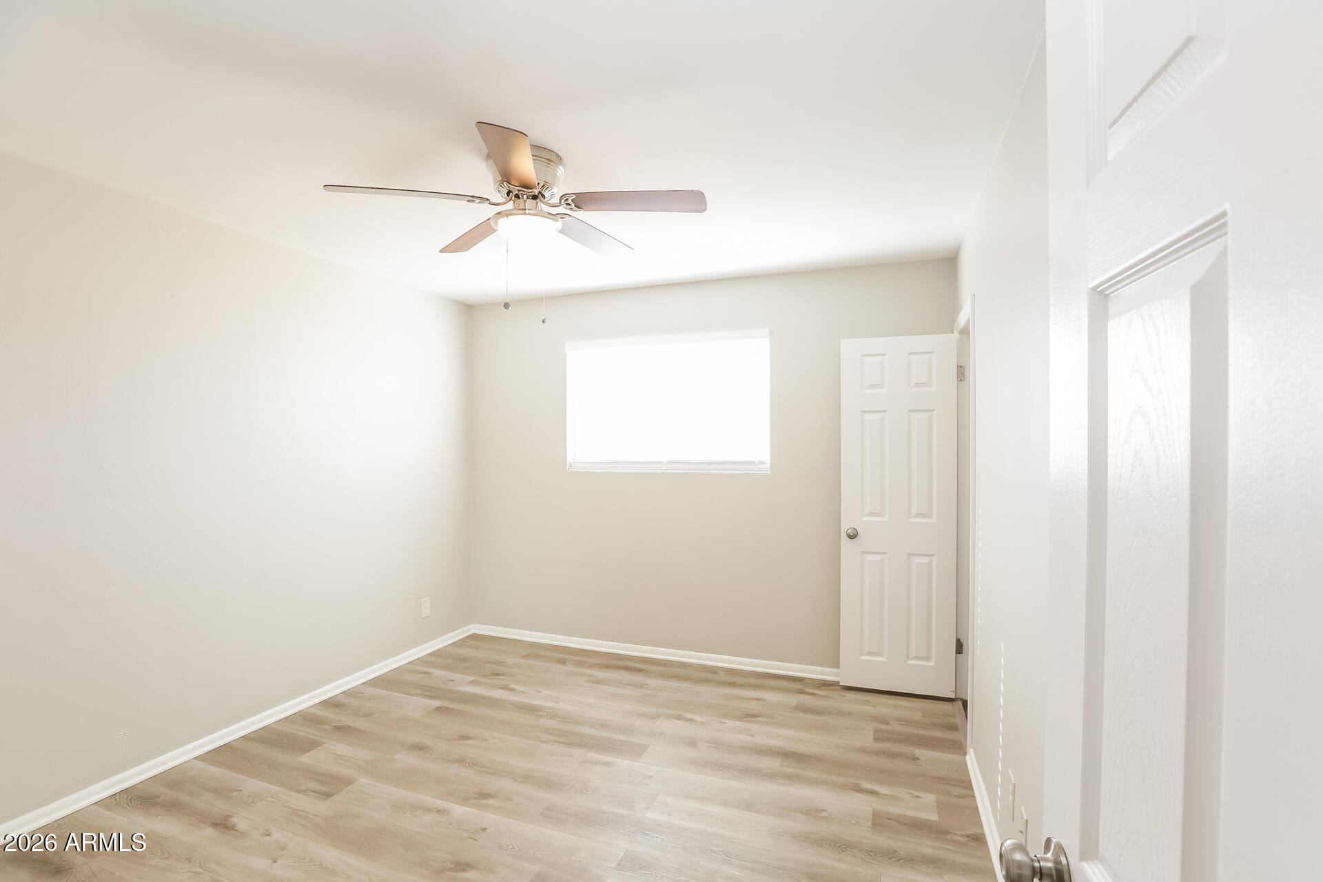 1323 West Romo Jones Street Tempe, AZ 85281 - Photo 7 of 16 a view of a room with wooden floor and a ceiling fan