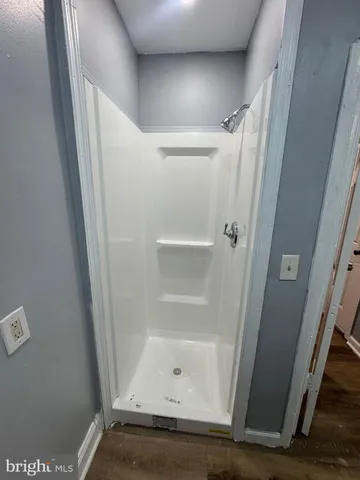 a bathroom with a glass door shower