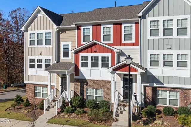 a front view of a residential apartment building with a yard