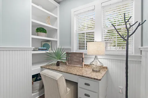 a bathroom with a granite countertop sink a large mirror and a window