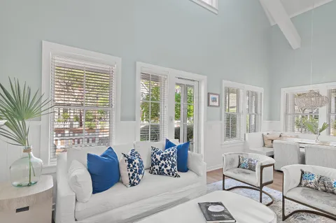 a living room with furniture and floor to ceiling windows