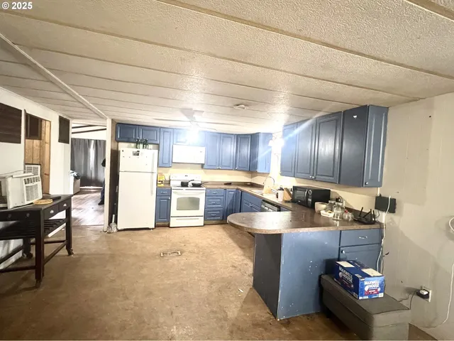 a kitchen with a refrigerator and a stove