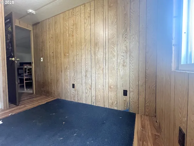 a view of a room with wooden floor and window