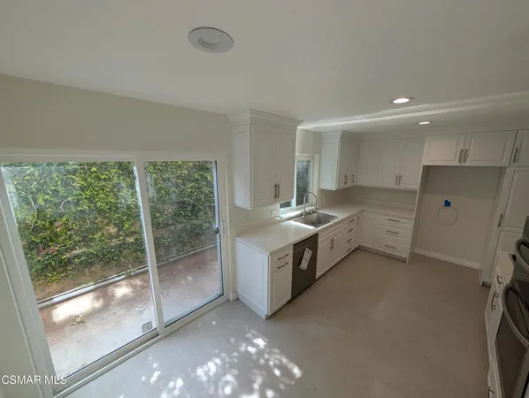 a spacious bathroom with stainless steel appliances double vanity and a shower