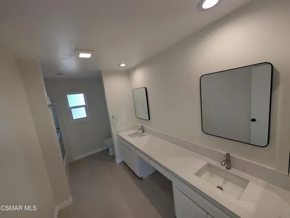a bathroom with a sink vanity and mirror