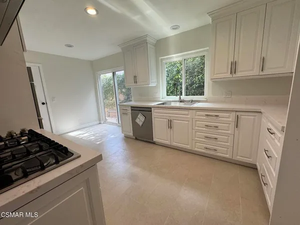 a kitchen with stainless steel appliances granite countertop a stove and a sink