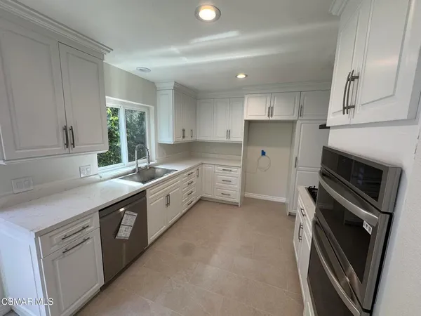 a kitchen with a sink stove and refrigerator