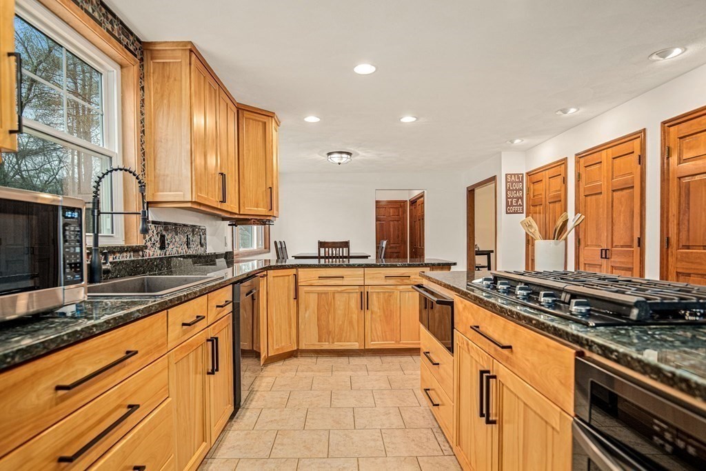 9 Spring Hill Road Merrimac, MA 01860 - Photo 4 of 41 a large kitchen with stainless steel appliances granite countertop a sink and cabinets