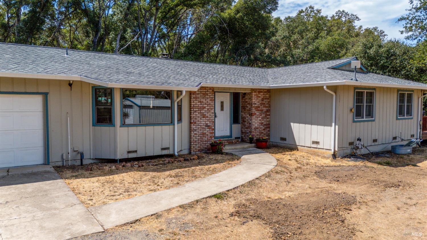 9510 West Potter Valley Road Potter Valley, CA 95469 - Photo 29 of 30 a front view of a house with a yard