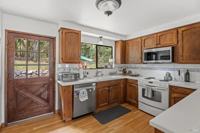 a kitchen with stainless steel appliances granite countertop a stove and a sink
