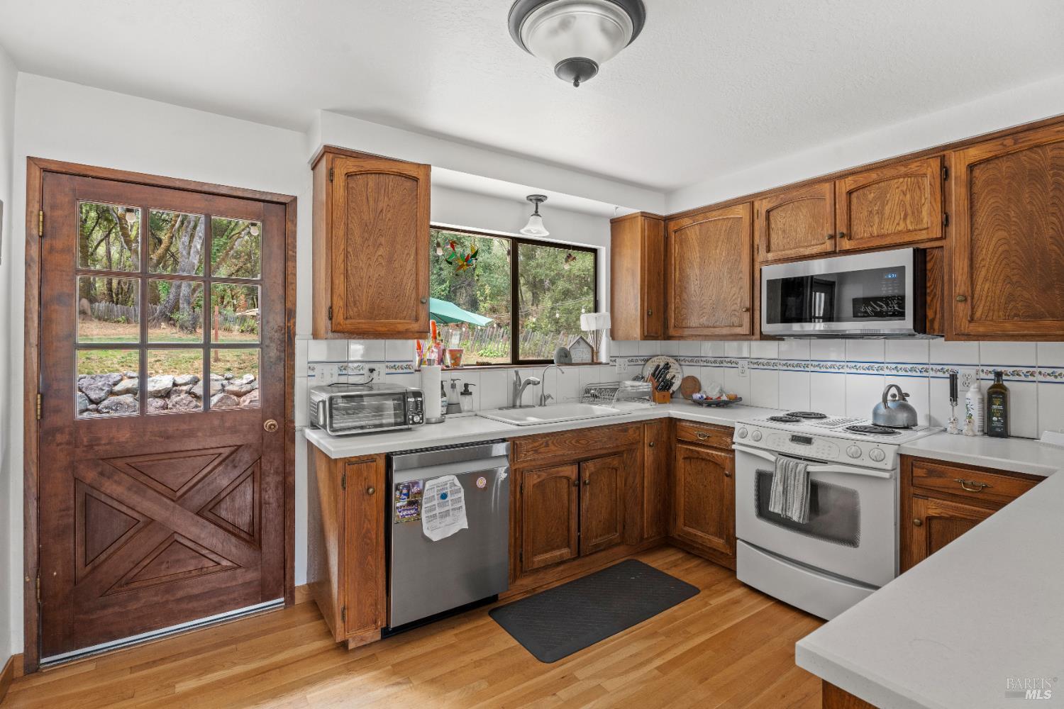 9510 West Potter Valley Road Potter Valley, CA 95469 - Photo 3 of 30 a kitchen with stainless steel appliances granite countertop a stove and a sink