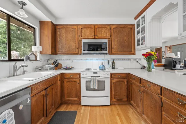 a kitchen with a sink stove and cabinets