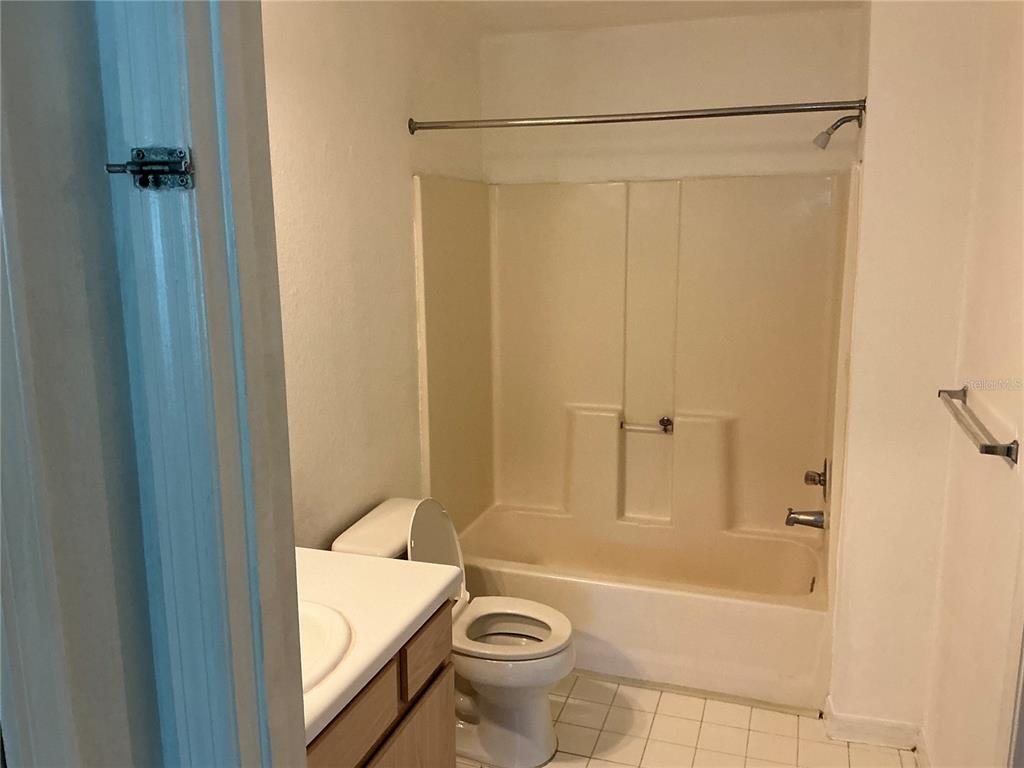 5459 Vineland Road, Unit 4307 Orlando, FL 32811 - Photo 2 of 7 a bathroom with a tub and a shower