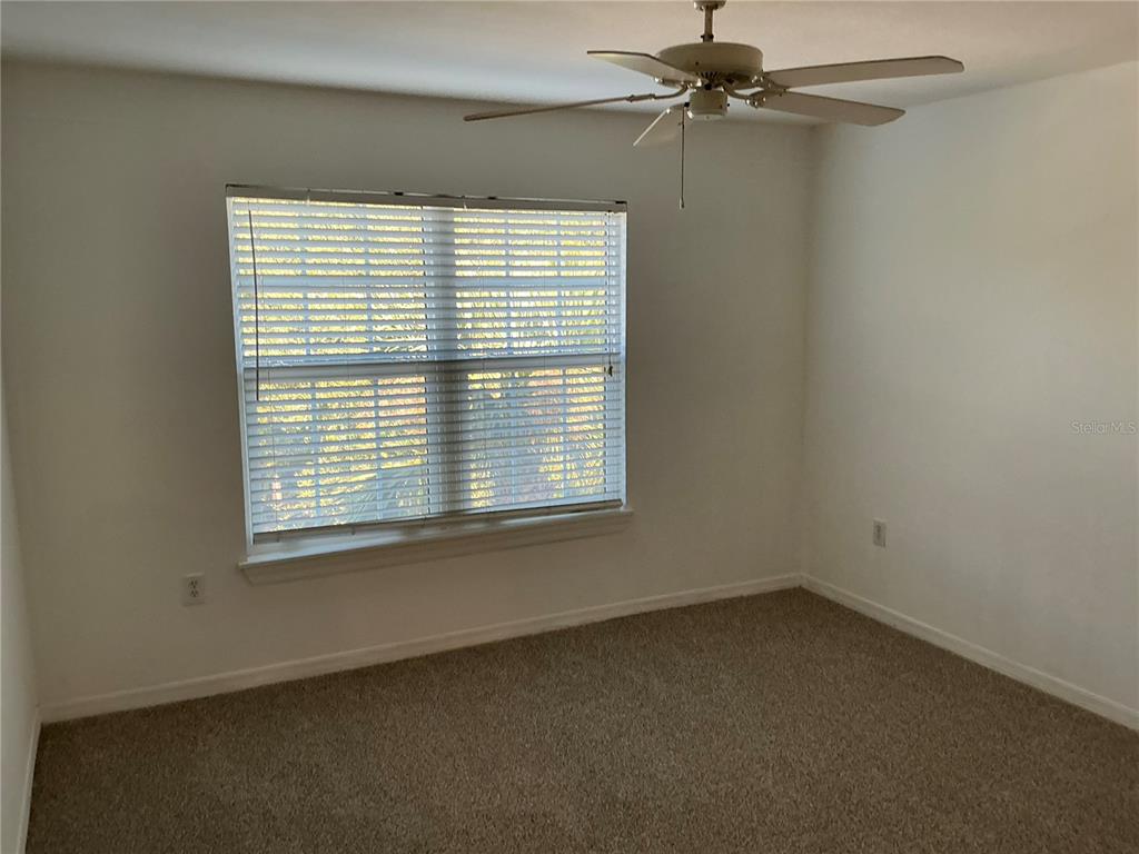 5459 Vineland Road, Unit 4307 Orlando, FL 32811 - Photo 6 of 7 an empty room with a window and a fan