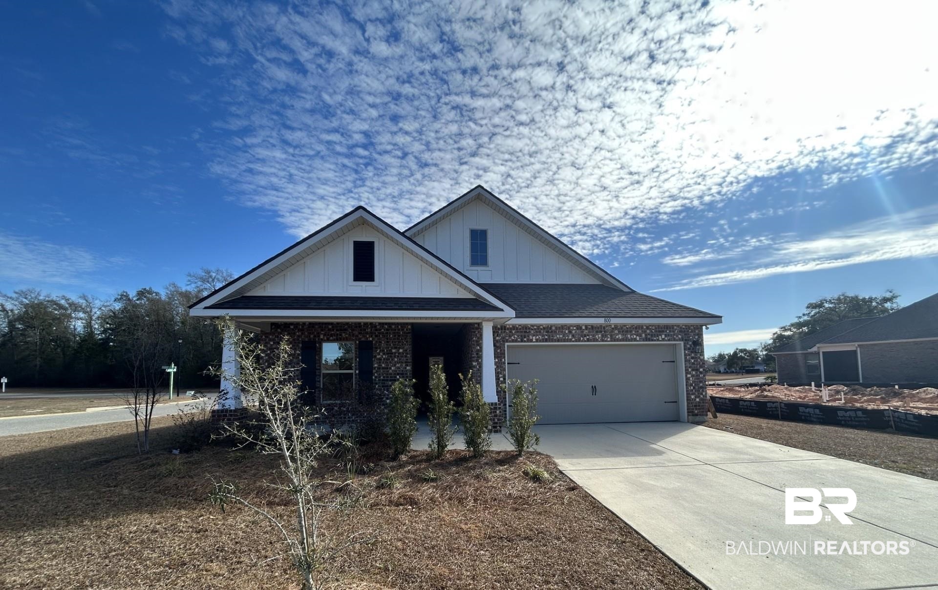 800 Sumter Loop Foley, AL 36535 - Photo 1 of 3 View of front of house with board and batten siding, brick siding, driveway, and covered porch