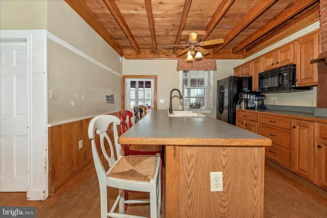 a dining room with a wooden table and chairs