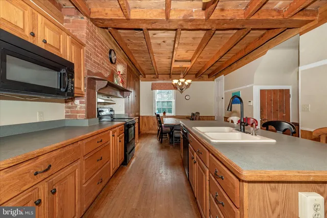a kitchen with stainless steel appliances granite countertop a stove and cabinets
